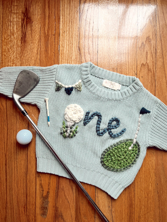 “Hole-in-one” first birthday sweater